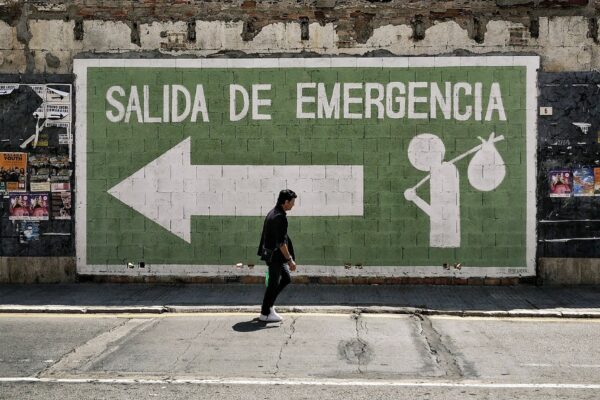 salida de emergencia emergency exit and man walking street in malaga spain